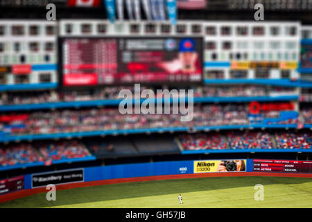 A lone player stands in the outfield as the Toronto Blue Jays play the Detroit Tigers on Canada Day at the Rogers Centre in Toronto, Canada. Stock Photo