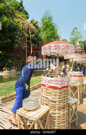 Offering sacred water to Buddha statues during Songkran,Wat Pan Tao, Chiang Mai, Thailand Stock Photo