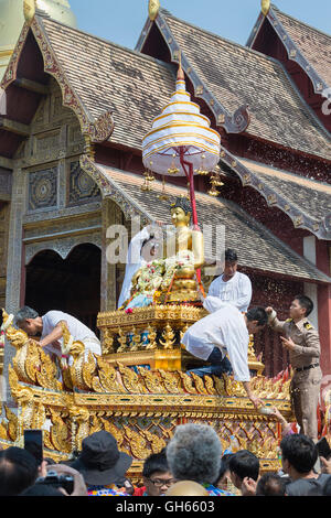 Worshippers  during Songkran pay homage and splash water on the Buddha image at Wat Phra Singh in Chiang Mai, Thailand Stock Photo