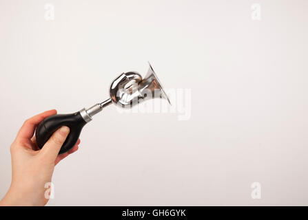 Hand holding the vintage manual air horn on white background. Stock Photo