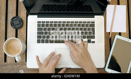 Person is typing on his laptop. Top view POV. Stock Photo