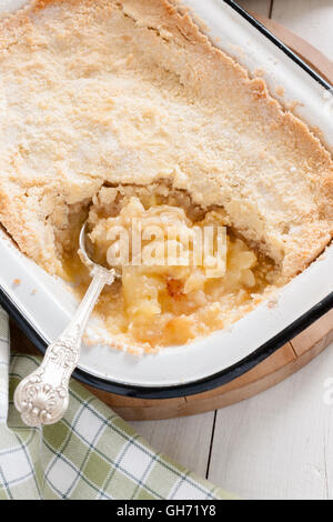 Home made Bramley apple crumble or apple cobbler stewed fruit with a crunchy topping Stock Photo