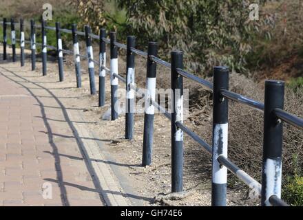 Road Fence. Black and white iron road fence, metal fencing Perspective. Stock Photo