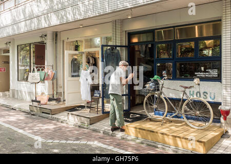 People stroll past shops in the Nakameguro area of Tokyo, Japan Stock Photo