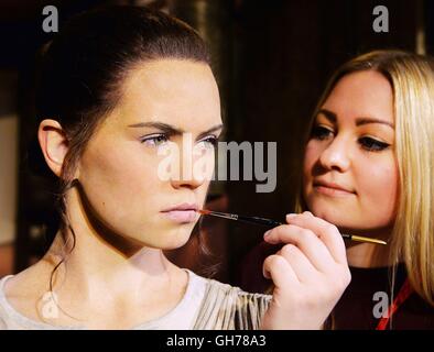 Make-up artist Vanessa Sallinger puts the finishing touches to the new wax figure of Star Wars: The Force Awakens character Rey, played by actress Daisy Ridley, at Madame Tussauds in London. Stock Photo