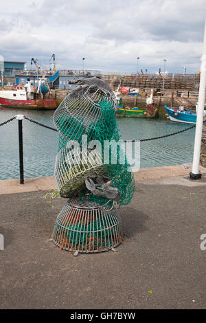 lobster or crab pots stacked on brixham harbourside Stock Photo