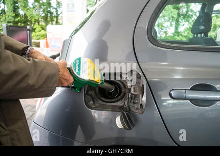 A customer filling a car with petrol. Stock Photo