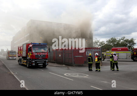 Marchwood, Hamphire, UK. 8th August 2016. Emergency crews from Hampshire fire and rescue service and South central  ambulance  service remain at the  cene of a  fire that broke out just after lunchtime today.  Fire crews have been brought from a far a field as Portsmouth to tackle the blaze at the fire at the recycling centre in East Road  Marchwood.  Eight fire engines two aerial ladders  and the incident command unit from Eastleigh been brought in to put out the fire out. Credit:  uknip/Alamy Live News Stock Photo