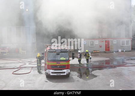 Marchwood, Hamphire, UK. 8th August 2016. Emergency crews from Hampshire fire and rescue service and South central  ambulance  service remain at the  cene of a  fire that broke out just after lunchtime today.  Fire crews have been brought from a far a field as Portsmouth to tackle the blaze at the fire at the recycling centre in East Road  Marchwood.  Eight fire engines two aerial ladders  and the incident command unit from Eastleigh been brought in to put out the fire out. Credit:  uknip/Alamy Live News Stock Photo