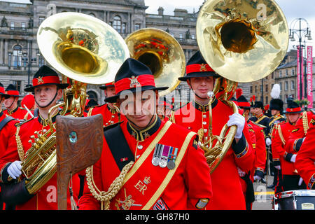 Glasgow, UK. 9th August, 2016. On the second day of 'Piping Life' the bands from The Royal Edinburgh Military Tattoo parade around George Square before entering the Piping Live arena for a spectacular display. The image is of members of the New Zealand Army Band with the distinctive Maori ethnic mace. Credit:  Findlay/Alamy Live News Stock Photo