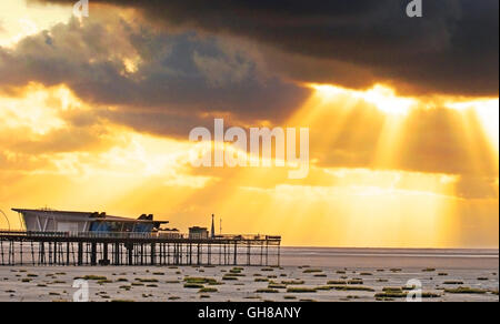 Southport Pier, Merseyside, UK. 9th August, 2016. After a day of heavy rain downpours and strong blustery winds, the sun finally breaks through the stormy clouds over the north west of England.  The unseasonal weather and cooler temperatures has kept some tourists away from the seaside resort of Southport.  Credit:  Cernan Elias/Alamy Live News Stock Photo