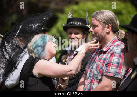 Woman checking a beard at the facial hair competition of papplewick pumping stations steam punk event Stock Photo