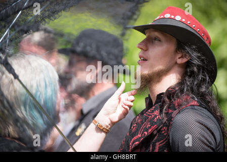 Woman checking a beard at the facial hair competition of papplewick pumping stations steam punk event Stock Photo