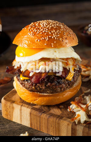 Homemade Breakfast Cheeseburger with Bacon Eggs and Hashbrowns Stock Photo
