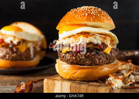 Homemade Breakfast Cheeseburger with Bacon Eggs and Hashbrowns Stock Photo