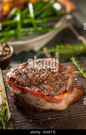 Organic Grass Fed Bacon Wrapped Sirloin Steak with Herbs Stock Photo