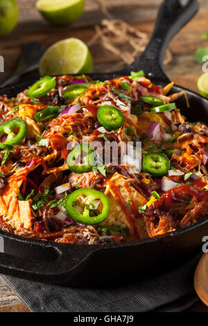 Homemade Barbecue Pulled Pork Nachos with Cheese and Peppers Stock Photo
