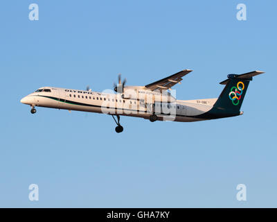 Olympic Air Bombardier Dash 8-Q400 turboprop passenger aircraft on approach at sunset Stock Photo