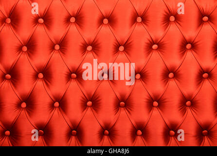 Red capitone textile background, retro Chesterfield style checkered soft tufted fabric furniture diamond pattern decoration with Stock Photo