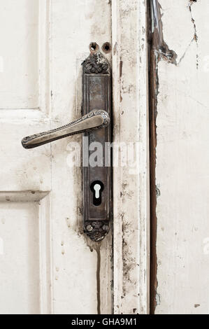 Old door handle on wooden door, BIGZ squat building, Belgrade Stock Photo