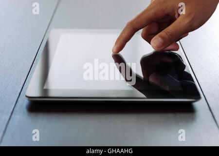 close hand touching on digital tablet Stock Photo