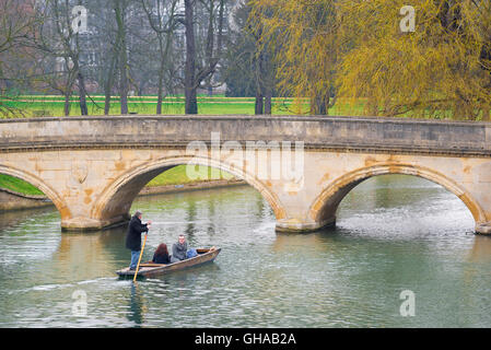 On an early spring morning in Cambridge, UK, tourists take a trip in a punt on the River Cam. Stock Photo