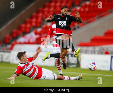Doncaster Rovers' Joe Wright (left) and Nottingham Forest's Armand Traore battle for the ball during the first round match of the Sky Bet EFL Cup at the Keepmoat Stadium, Doncaster. Stock Photo