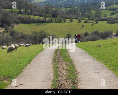 Couple walking The Limestone Way near Robin Hood's Stride close to Birchover, Derbyshire, UK Stock Photo