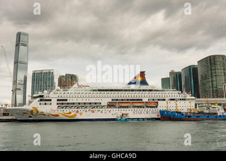 HONG KONG - JANUARY 11: Victoria Harbor on January 21, 2016 in Hong Kong. Big Cruise Ship on Terminal near Victoria Harbor. Stock Photo