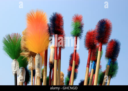 Plastic broom. These are plastic broom on sky background for cleaning the home. Stock Photo
