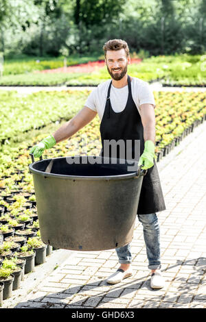 Handsome gardener with huge bucket Stock Photo