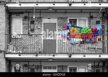 Colourful washing hanging outside flat in Bethnal Green area, city of London UK in July in monochrome with selective colour colouring, colour popping
