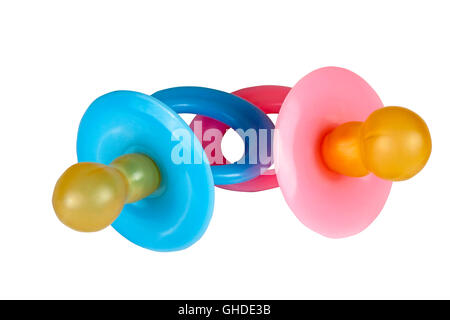 Close up isolated pair of blue and pink baby pacifier dummies in on white background Stock Photo