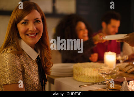 Portrait smiling woman at candlelight table Stock Photo