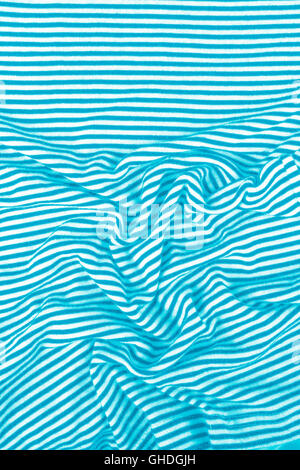 Striped wrinkled turquoise (green / blue) and white zebra fabric cloth background Stock Photo