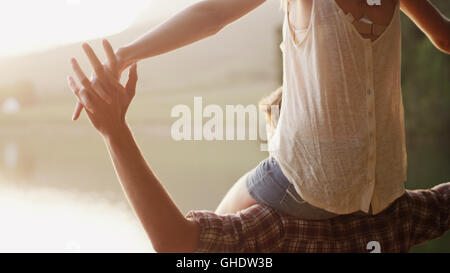 Young man carrying woman on shoulders Stock Photo