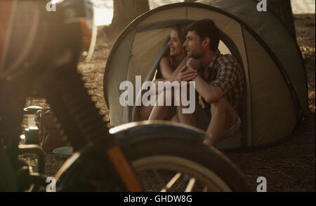 Affectionate young couple in tent Stock Photo