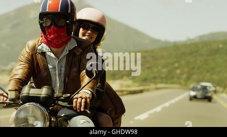 Young couple riding motorcycle on sunny road Stock Photo