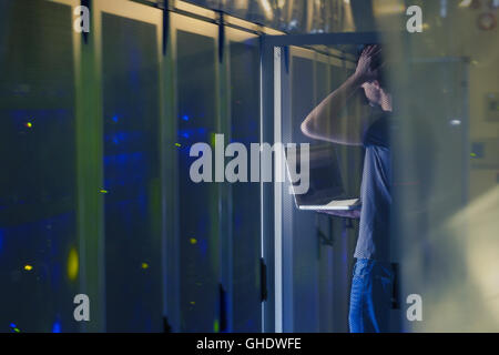 Server room technician with laptop Stock Photo