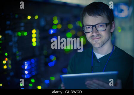 Portrait confident server room technician with digital tablet Stock Photo