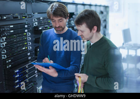 Server room technicians with clipboard Stock Photo