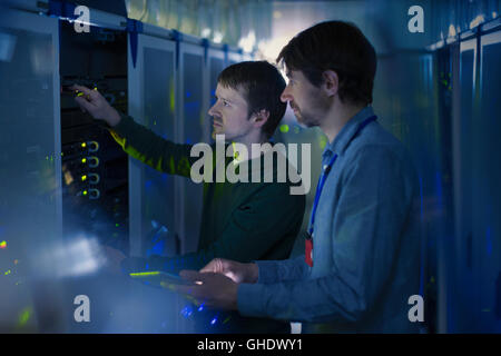 Server room technicians working on panel Stock Photo