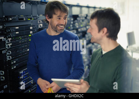Server room technicians using digital tablet Stock Photo