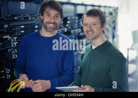 Portrait confident server room technicians Stock Photo