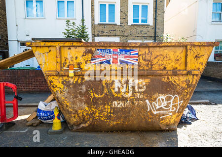 Yellow Skip outside a house renovation in South East London, Southwark, England, UK Stock Photo