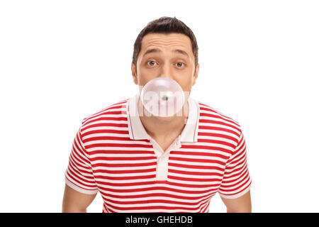 Young guy blowing up a bubble from a chewing gum isolated on white background Stock Photo