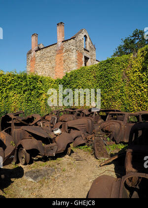 Oradour sur Glane war memorial village ruins, Haute Vienne, France with many rusty car wrecks Stock Photo