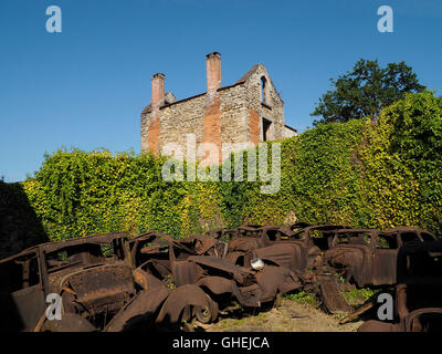 Oradour sur Glane war memorial village ruins, Haute Vienne, France with many rusty car wrecks. Stock Photo