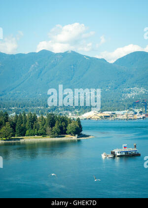 Elevated view: Coal Harbour, the floating Chevron fuel station, Stanley Park, Vancouver Harbour, and Grouse Mountain. Vancouver. Stock Photo