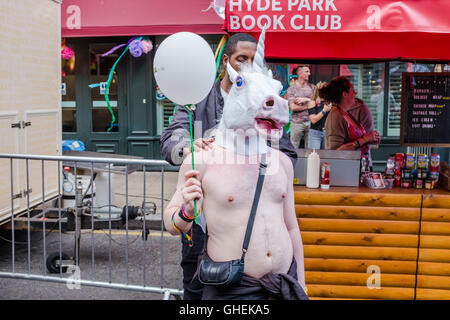 Man waring horses head holding a balloon at Leeds Gay Pride 2016, LGBT 10th anniversary celebration Stock Photo
